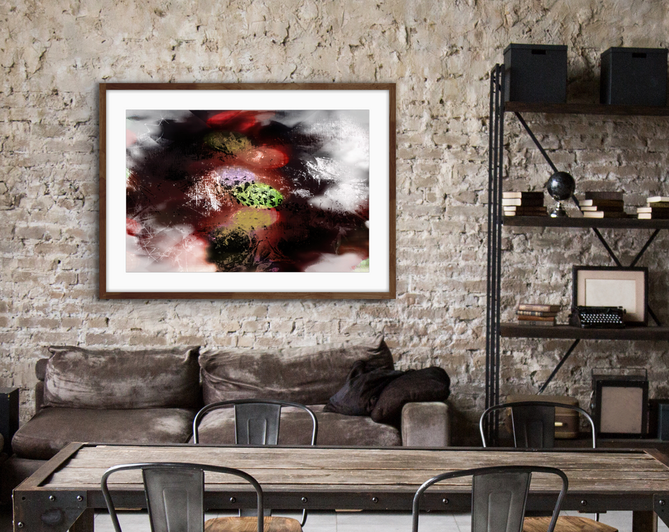 Framed version of Chaos by Claire Donnison hanging in landscape orientation on a brick wall above a brown leather couch situated next to a metal shelf unit and just behind a table and chairs. Showing a studio apartment vibe.